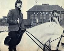 John Lennon on a horse with Paul nearby