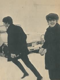 Ringo Starr and John Lennon in the snow near a car